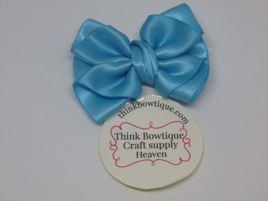 Make a Amelia ribbon bow with turquoise satin ribbon